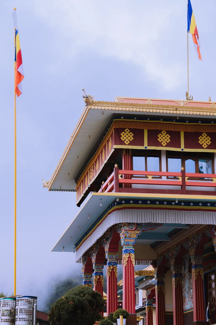 Tibetan Buddhist monastery with prayer wheels and flags, representing devotion